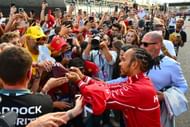 Lewis Hamilton of Great Britain and Scuderia Ferrari signs autographs for fans during previews ahead of the F1 Grand Prix of Azerbaijan - Source: Getty